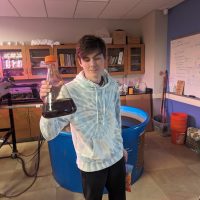 Student holding something from their shop